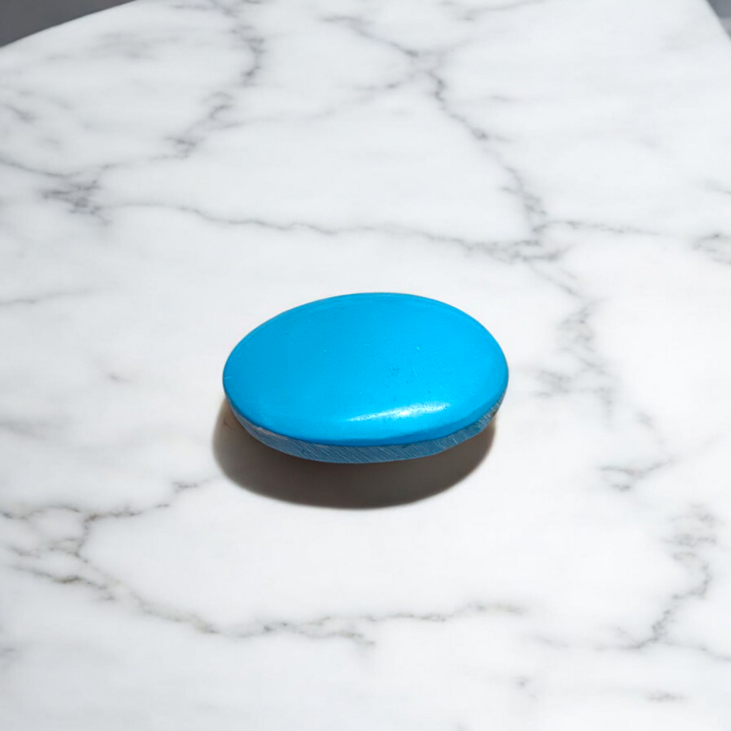 Close-up image of an Original Turquoise (Firoza) Stone with smooth polish and natural color patterns, ideal for healing and confidence