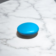 Close-up image of an Original Turquoise (Firoza) Stone with smooth polish and natural color patterns, ideal for healing and confidence