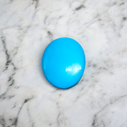 Close-up image of an Original Turquoise (Firoza) Stone with smooth polish and natural color patterns, ideal for healing and confidence
