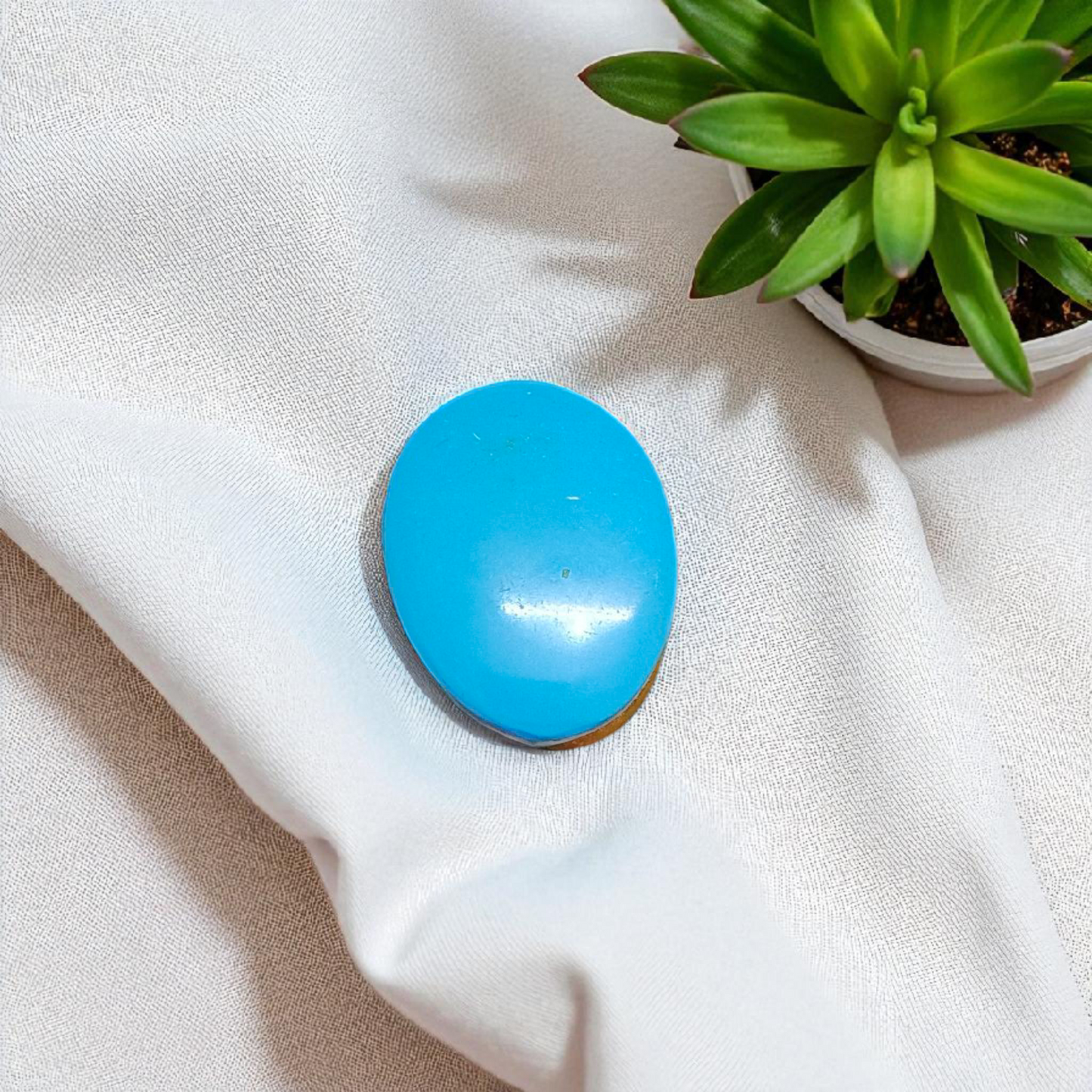 Close-up image of an Original Turquoise (Firoza) Stone with smooth polish and natural color patterns, ideal for healing and confidence