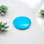 Close-up image of an Original Turquoise (Firoza) Stone with smooth polish and natural color patterns, ideal for healing and confidence