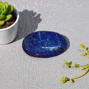 Close-up image of polished Lapis Lazuli stone by MALAWALA showing deep blue color and natural gold flecks