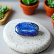Close-up image of polished Lapis Lazuli stone by MALAWALA showing deep blue color and natural gold flecks