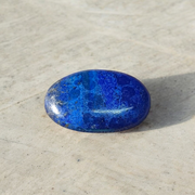 Close-up image of polished Lapis Lazuli stone by MALAWALA showing deep blue color and natural gold flecks