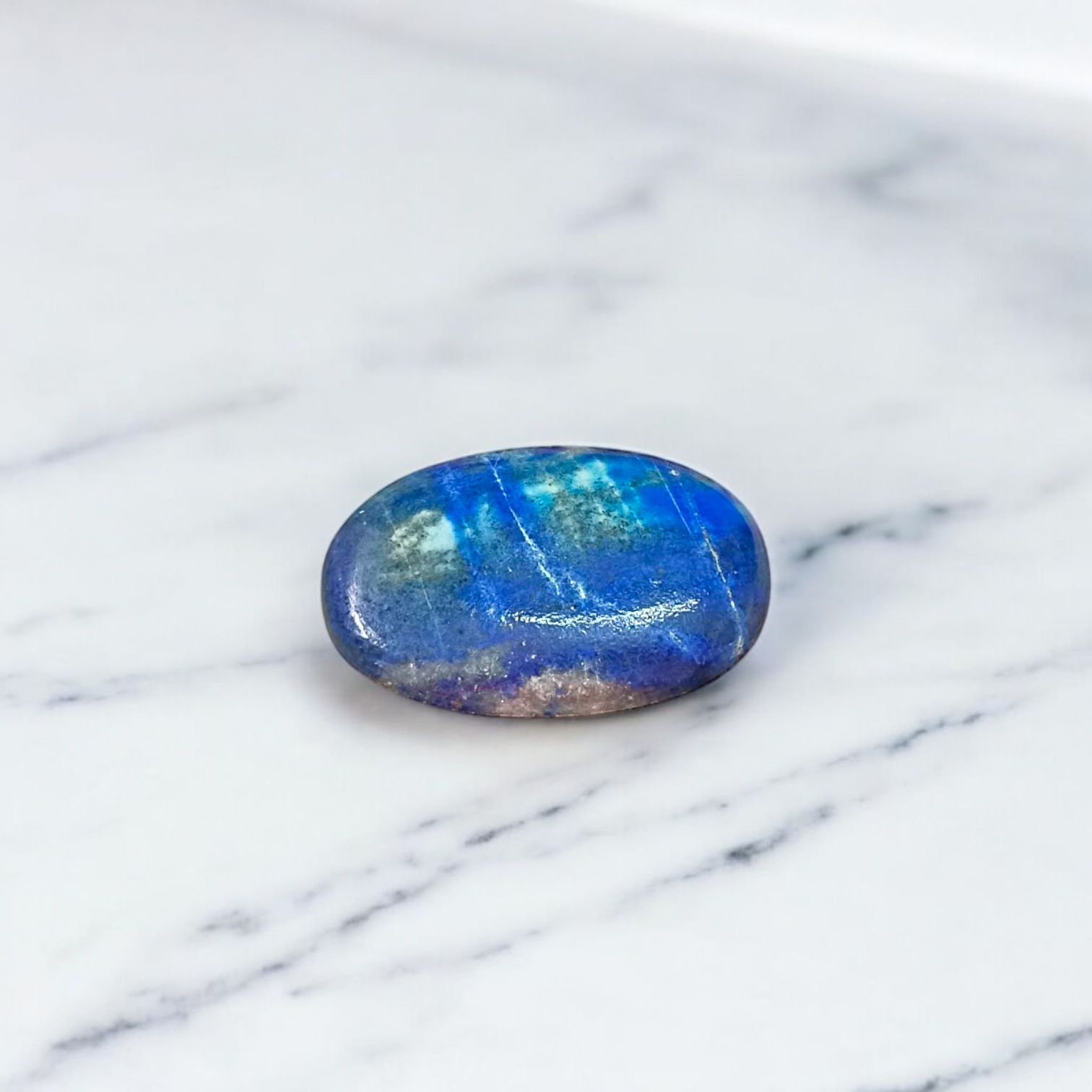 Close-up image of polished Lapis Lazuli stone by MALAWALA showing deep blue color and natural gold flecks