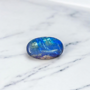 Close-up image of polished Lapis Lazuli stone by MALAWALA showing deep blue color and natural gold flecks