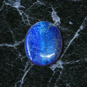 Close-up image of polished Lapis Lazuli stone by MALAWALA showing deep blue color and natural gold flecks