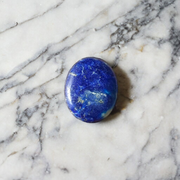 Close-up image of polished Lapis Lazuli stone by MALAWALA showing deep blue color and natural gold flecks