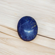 Close-up image of polished Lapis Lazuli stone by MALAWALA showing deep blue color and natural gold flecks