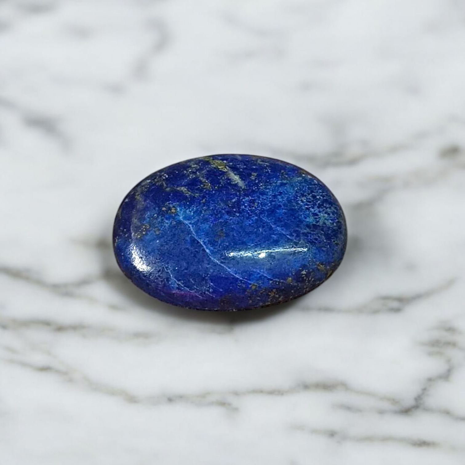 Close-up image of polished Lapis Lazuli stone by MALAWALA showing deep blue color and natural gold flecks