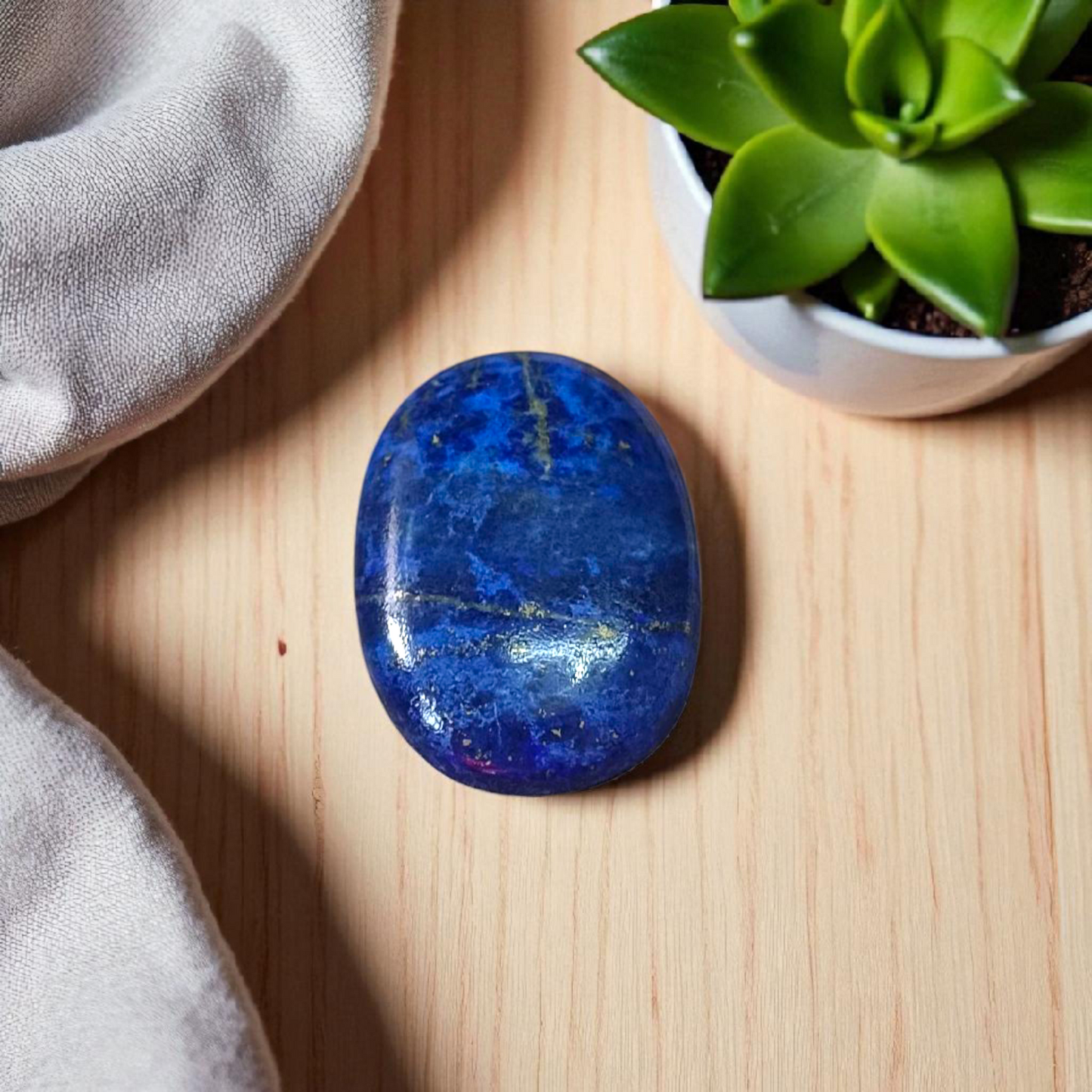 Close-up image of polished Lapis Lazuli stone by MALAWALA showing deep blue color and natural gold flecks