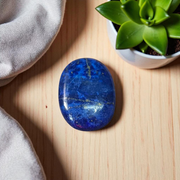 Close-up image of polished Lapis Lazuli stone by MALAWALA showing deep blue color and natural gold flecks