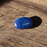 Close-up image of polished Lapis Lazuli stone by MALAWALA showing deep blue color and natural gold flecks