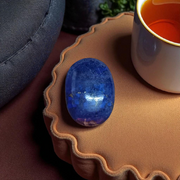 Close-up image of polished Lapis Lazuli stone by MALAWALA showing deep blue color and natural gold flecks
