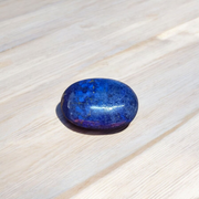 Close-up image of polished Lapis Lazuli stone by MALAWALA showing deep blue color and natural gold flecks