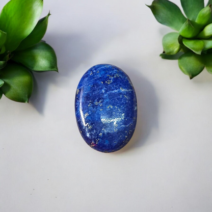 Close-up image of polished Lapis Lazuli stone by MALAWALA showing deep blue color and natural gold flecks