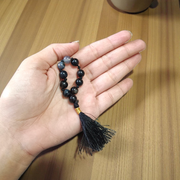 Close-up of MALAWALA Natural Black Sulemani Finger Mala with 9+1 polished 8mm beads, ideal for meditation, chanting, and daily wear