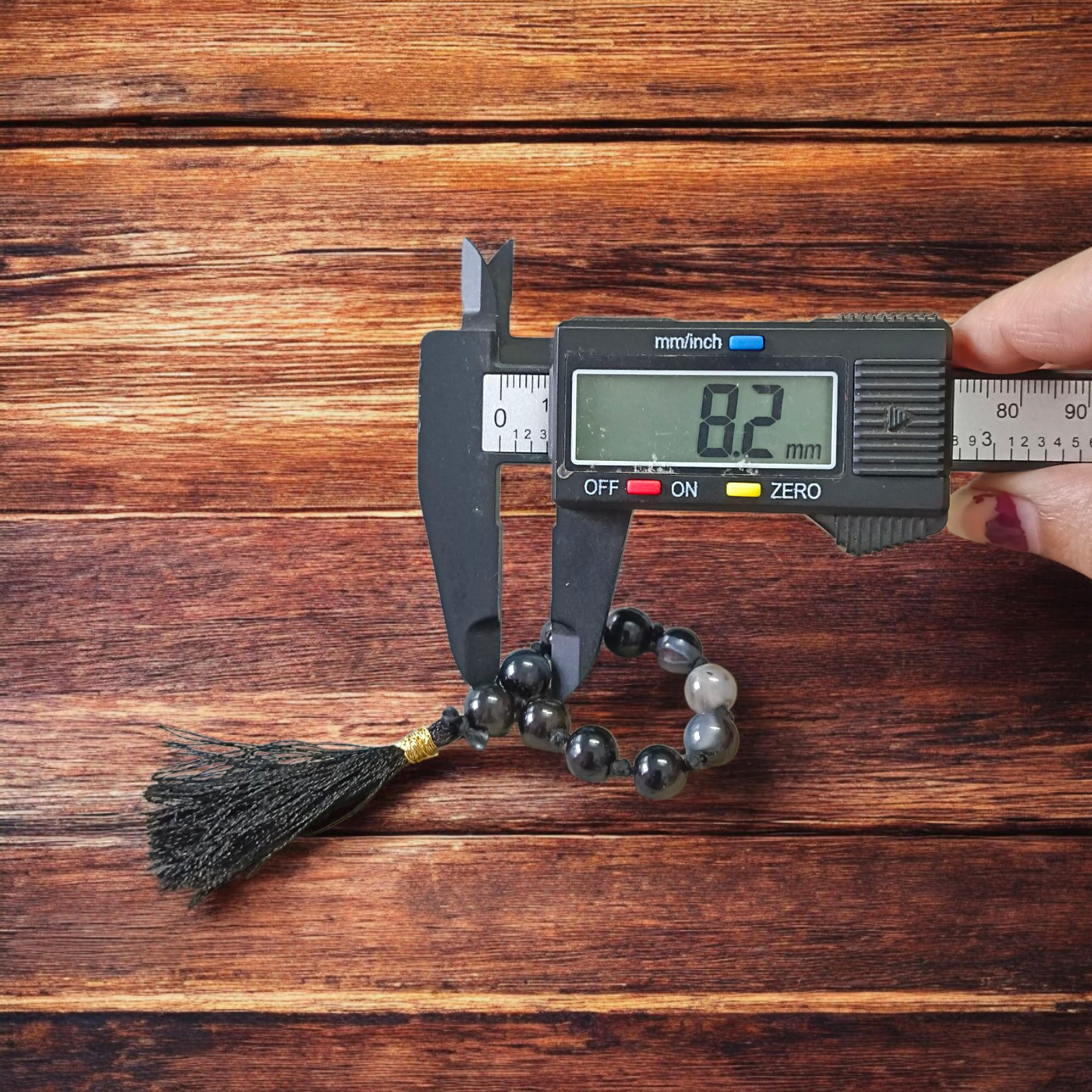 Close-up of MALAWALA Natural Black Sulemani Finger Mala with 9+1 polished 8mm beads, ideal for meditation, chanting, and daily wear