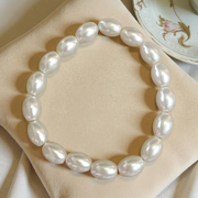 Close-up of MALAWALA Natural Pearl Bracelet featuring 10–11mm round white pearls on elastic thread, ideal for daily wear, meditation, and gifting