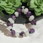 Close-up of Natural Amethyst and White Agate bracelet with polished beads for meditation and healing