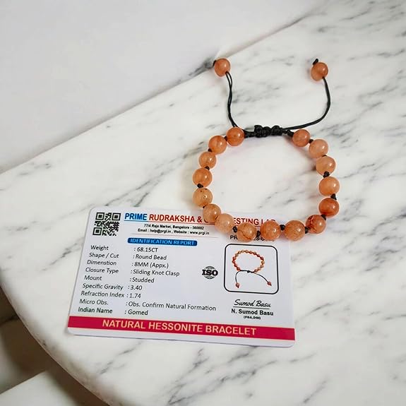 Close-up of Natural Gomed (Hessonite) 8MM bracelet with polished beads on elastic string