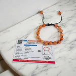 Close-up of Natural Gomed (Hessonite) 8MM bracelet with polished beads on elastic string