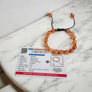 Close-up of Natural Gomed (Hessonite) 8MM bracelet with polished beads on elastic string