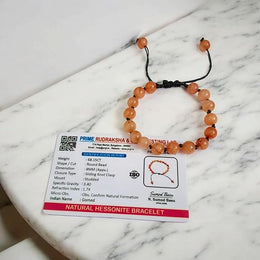 Close-up of Natural Gomed (Hessonite) 8MM bracelet with polished beads on elastic string