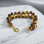 Close-up of Natural Tiger Eye Bracelet with polished 7MM beads on elastic band
