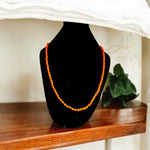 Close-up of Orange Monga Mala with 108+1 natural coral beads, traditionally hand-knotted for spiritual and astrological use
