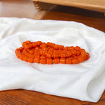 Close-up of Orange Monga Mala with 108+1 natural coral beads, traditionally hand-knotted for spiritual and astrological use