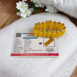 Close-up of Yellow Hakik Agate Bracelet with 8MM polished natural beads arranged in a circular pattern on a neutral background