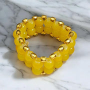 Close-up of Yellow Hakik Agate Bracelet with 8MM polished natural beads arranged in a circular pattern on a neutral background