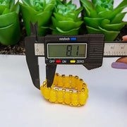 Close-up of Yellow Hakik Agate Bracelet with 8MM polished natural beads arranged in a circular pattern on a neutral background