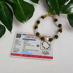 Close-up of a handcrafted lava bracelet featuring genuine lab-certified black lava beads on an elastic cord