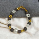 Close-up of a handcrafted lava bracelet featuring genuine lab-certified black lava beads on an elastic cord