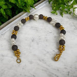 Close-up of a handcrafted lava bracelet featuring genuine lab-certified black lava beads on an elastic cord