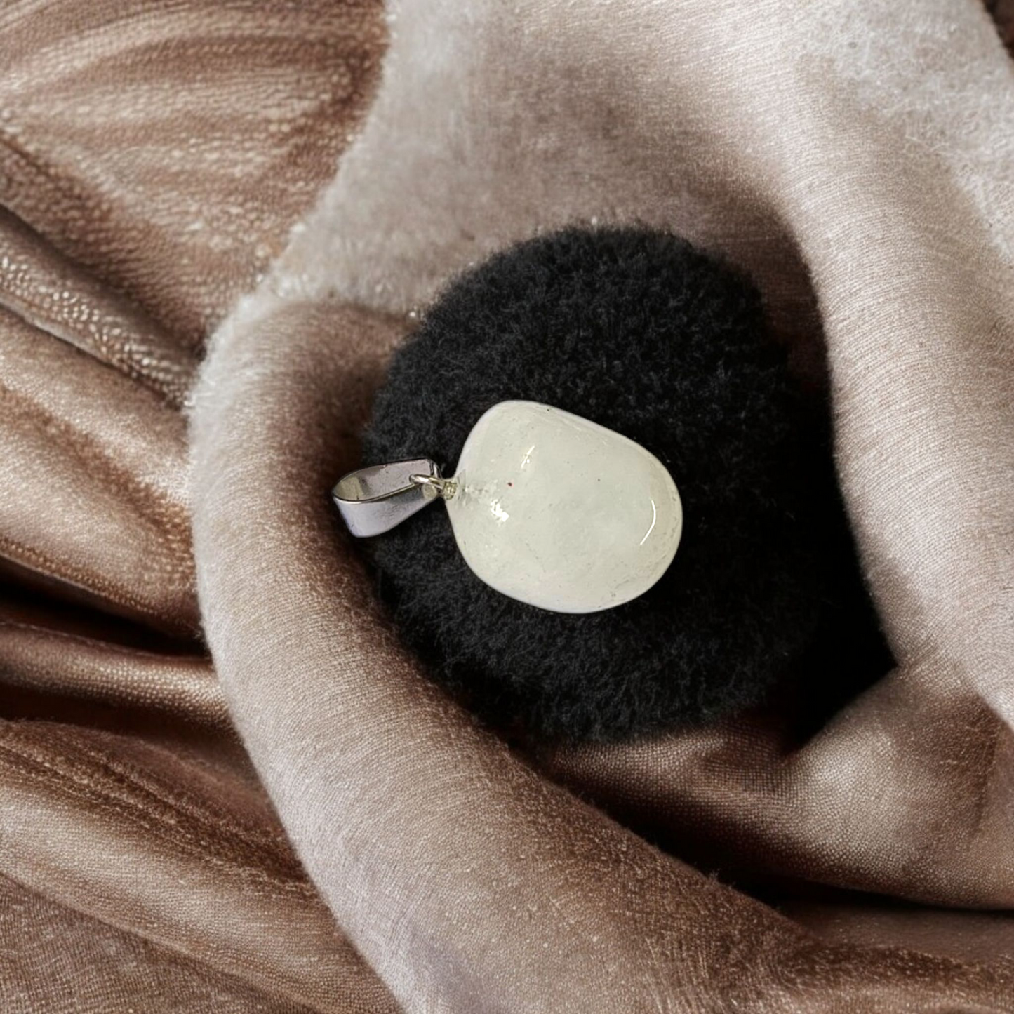 Close-up of a rough raw crystal quartz pendant with stainless steel chain, showcasing natural stone texture and clarity