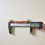 Close-up of an 8MM 2 Mukhi Rudraksha bracelet with uniform brown beads arranged in a stretchable loop on a white background