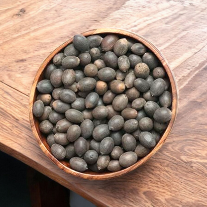 Close-up of natural Kamal Gutta (lotus seeds), lab-certified, displayed on a white background with subtle spiritual elements