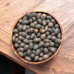 Close-up of natural Kamal Gutta (lotus seeds), lab-certified, displayed on a white background with subtle spiritual elements