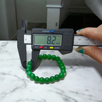 Close-up of stretchable Green Onyx Bracelet with 8mm polished beads, designed by MALAWALA