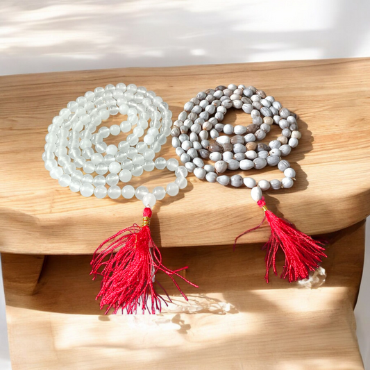 Combo set of Crystal (Sphatik) Mala and Vaijanti Mala placed on a sacred cloth, highlighting their beads and craftsmanship