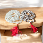 Combo set of Crystal (Sphatik) Mala and Vaijanti Mala placed on a sacred cloth, highlighting their beads and craftsmanship