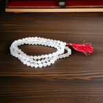 Combo set of Crystal (Sphatik) Mala and Vaijanti Mala placed on a sacred cloth, highlighting their beads and craftsmanship