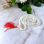 Combo set of Crystal (Sphatik) Mala and Vaijanti Mala placed on a sacred cloth, highlighting their beads and craftsmanship