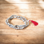 Combo set of Crystal (Sphatik) Mala and Vaijanti Mala placed on a sacred cloth, highlighting their beads and craftsmanship