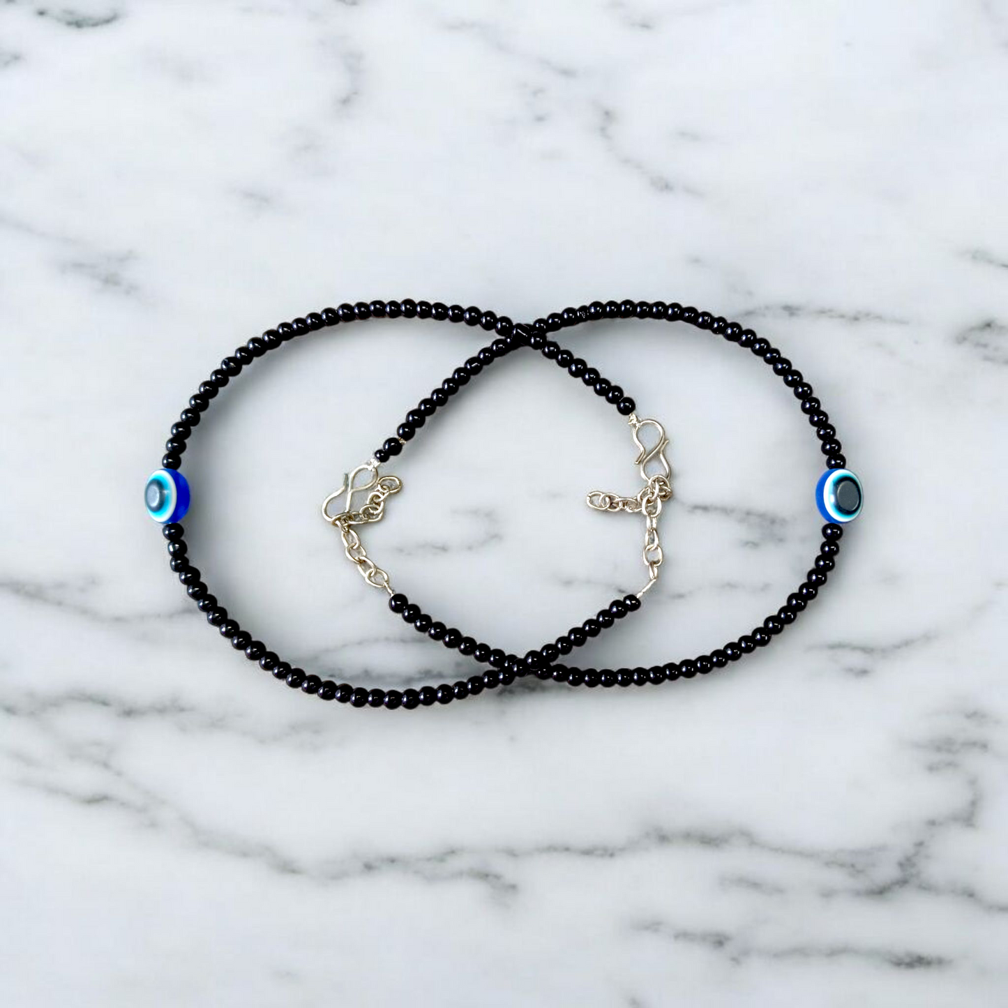 Elegant anklet with blue evil eye charm for girls and women, featuring adjustable chain and delicate bead detailing, designed for protection and style