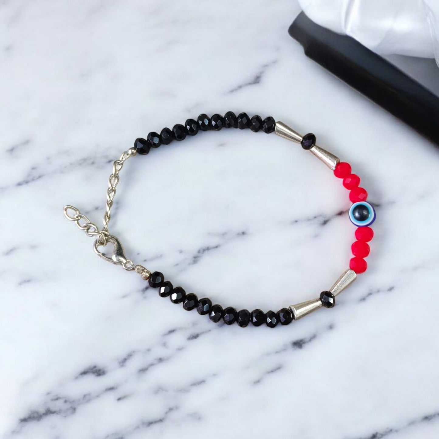 Evil Eye Anklet for Kids featuring black and red beads with stretchable design, ideal for daily wear and spiritual protection