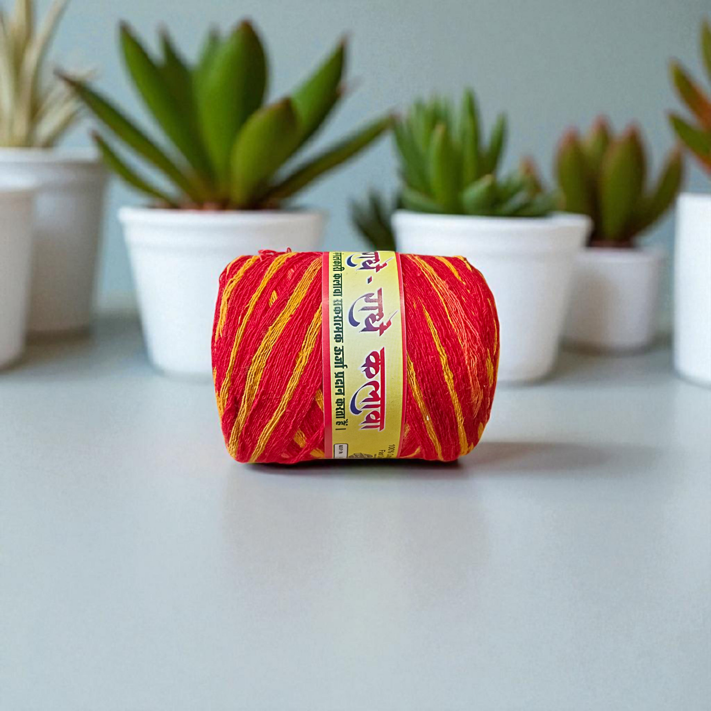 Extra-large red and yellow twisted cotton Moli Kalawa thread rolled neatly, ideal for pooja and Raksha Bandhan rituals